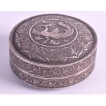 AN EARLY 20TH CENTURY INDIAN SILVER CIRCULAR BOX AND COVER repousse decorated with a bird and floral