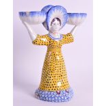 A 19TH CENTURY FRENCH FAIENCE POTTERY FIGURAL DOUBLE SALT in the form of a standing female holding