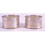 A PAIR OF LATE VICTORIAN CASED SILVER NAPKIN RINGS London 1898. 2ins diameter.