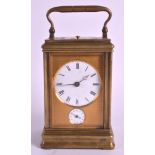 A LATE 19TH CENTURY FRENCH BRASS CARRIAGE CLOCK with twin enamelled circular dial and engine