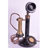 AN UNUSUAL 1930S 'CANDLE AND WALL' TELEPHONE upon circular plinth. 1ft 1ins high.