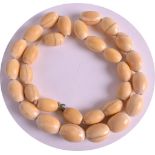 AN EARLY 20TH CENTURY EUROPEAN IVORY NECKLACE with oval carved beads. Overall 2ft long. Weight: 97g