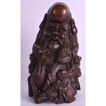 A 19TH CENTURY CHINESE CARVED BAMBOO FIGURE OF SAGE modelled holding a peach, with a goat by his