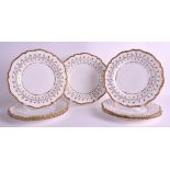 A SET OF SEVEN EARLY 19TH CENTURY BARR WORCESTER SCALLOPED PLATES painted with trailing gilt