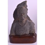 AN EARLY INDIAN CARVED GRAY SCHIST HEAD OF A BUDDHA the fragment elegantly modelled, supported