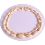 AN EARLY 20TH CENTURY CARVED IVORY NECKLACE of graduated form, comprising of 44 beads. 77grams.