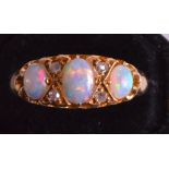 AN EDWARDIAN 18K YELLOW GOLD OPAL AND DIAMOND RING.