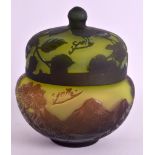 A GALLE STYLE CAMEO GLASS JAR AND COVER decorated with landscapes and foliage. 4.25ins diameter.