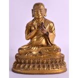 A CHINESE QING DYNASTY GILT BRONZE FIGURE OF A BUDDHISTIC LAMA probably C1800, modelled with one