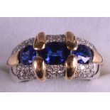 AN 18K LADIES YELLOW GOLD, SAPPHIRE AND DIAMOND RING.