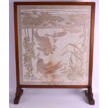 AN EARLY 20TH CENTURY CARVED OAK FIRE SCREEN inset with a Taisho period Japanese silkwork of carp