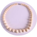 AN EARLY 20TH CENTURY CARVED IVORY NECKLACE of graduated form, comprising of 39 beads. 79grams.