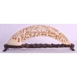 A 19TH CENTURY CHINESE CANTON CARVED IVORY TUSK depicting numerous figures upon a hillside. Ivory