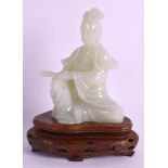 AN EARLY 20TH CENTURY CHINESE CARVED JADE FIGURE OF GUANYIN Late Qing, modelled holding a fan in