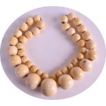 A 19TH CENTURY CARVED IVORY NECKLACE of graduated form, comprising of 42 beads. 124grams. 1ft