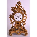 A LATE 19TH CENTURY ORMOLU MANTEL CLOCK with white enamel dial, of elaborate rococo form. 11.5ins