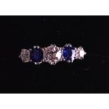 AN 18CT LADIES WHITE GOLD DIAMOND AND BLUE SAPPHIRE ETERNITY RING. 3.8 grams.