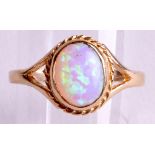 A 9CT GOLD AND SYNTHETIC OPAL RING.