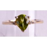 A 9CT GOLD PERIDOT & DIAMOND RING.