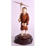 AN EARLY 20TH CENTURY JAPANESE MEIJI PERIOD CARVED IVORY AND BOXWOOD OKIMONO modelled as a young boy