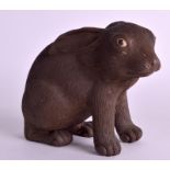 A 19TH CENTURY JAPANESE MEIJI PERIOD POTTERY FIGURE OF A RABBIT modelled with resting on front legs.