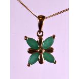 A 9CT YELLOW GOLD EMERALD PENDANT AND CHAIN SET.