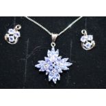 A 9CT WHITE GOLD DIAMOND AND TANZANITE EARRING & PENDANT SET.