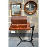 A SINGER SEWING MACHINE with wrought iron and oak sewing stand, together with two gilt framed