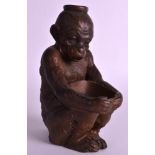 A 19TH CENTURY JAPANESE MEIJI PERIOD POTTERY FIGURE OF A MONKEY modelled holding a planter. 7.5ins