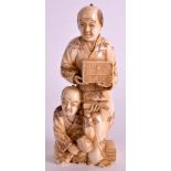 A 19TH CENTURY JAPANESE MEIJI PERIOD IVORY OKIMONO well carved as a male holding a carved box with