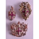 A FINE SILVER GILT AND ENAMEL SET OF THREE ROYAL BROOCHES by Kenning & Spencer, with pink stone