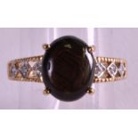 A 9CT GOLD BROWN STAR SAPPHIRE AND DIAMOND RING.