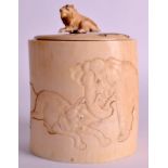 A 19TH CENTURY JAPANESE MEIJI PERIOD IVORY TUSK VASE AND COVER carved with elephants fighting within