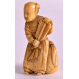 A 19TH CENTURY JAPANESE MEIJI PERIOD CARVED IVORY NETSUKE depicting a standing female holding a fan.