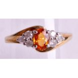 A 9CT GOLD ORANGE SAPPHIRE AND DIAMOND RING.