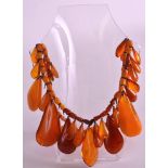 AN ART DECO EUROPEAN ORANGE AMBER LADIES NECKLACE with hanging drops. 130 grams.