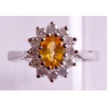 A 9CT WHITE GOLD YELLOW SAPPHIRE AND DIAMOND CLUSTER RING.