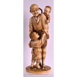 A 19TH CENTURY JAPANESE MEIJI PERIOD TOKYO SCHOOL IVORY OKIMONO modelled as a father and two sons