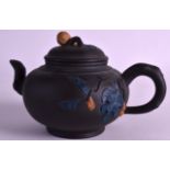 A CHINESE YIXING POTTERY TEAPOT AND COVER 20th century, decorated with foliage, together with a