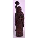 A FINE CHINESE QING DYNASTY CARVED BAMBOO FIGURE OF SHOULAO modelled holding a foliate staff and