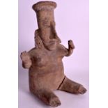 A PRE COLUMBIAN POTTERY FIGURE OF A FEMALE modelled with both hands raised. 1Ft 2ins high.