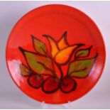 A 1970S POOLE POTTERY ORANGE GLAZED BOWL painted with fruit. 10Ins diameter.