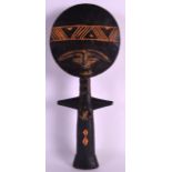 A CARVED AFRICAN TRIBAL FIGURE 20th Century, with flat circular head. 1Ft 1ins long.