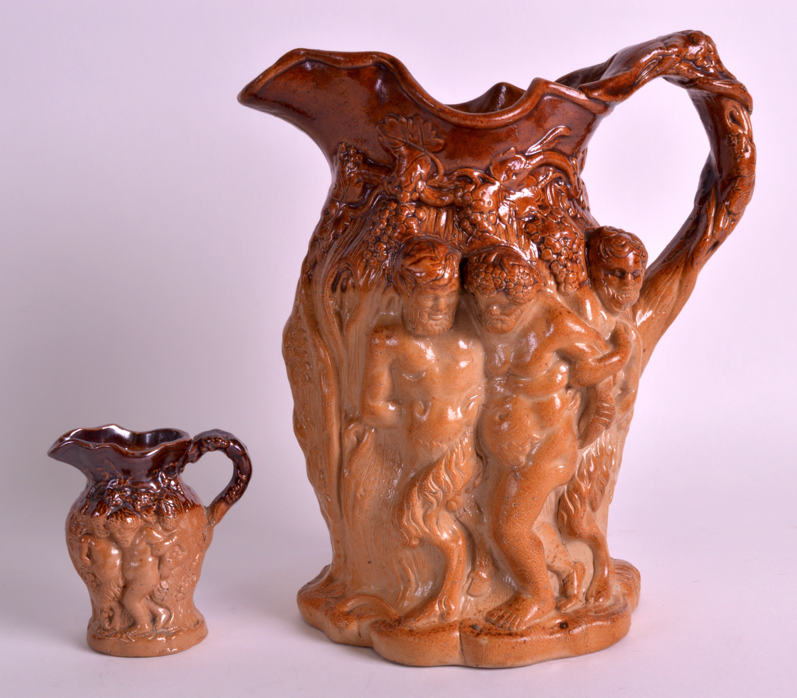 A 19TH CENTURY ENGLISH STONEWARE JUG decorated with classical figures in relief, together with a