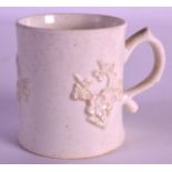 AN 18TH CENTURY BOW BLANC DE CHINE MUG of waisted form, decorated with applied sprigs. 2.75ins