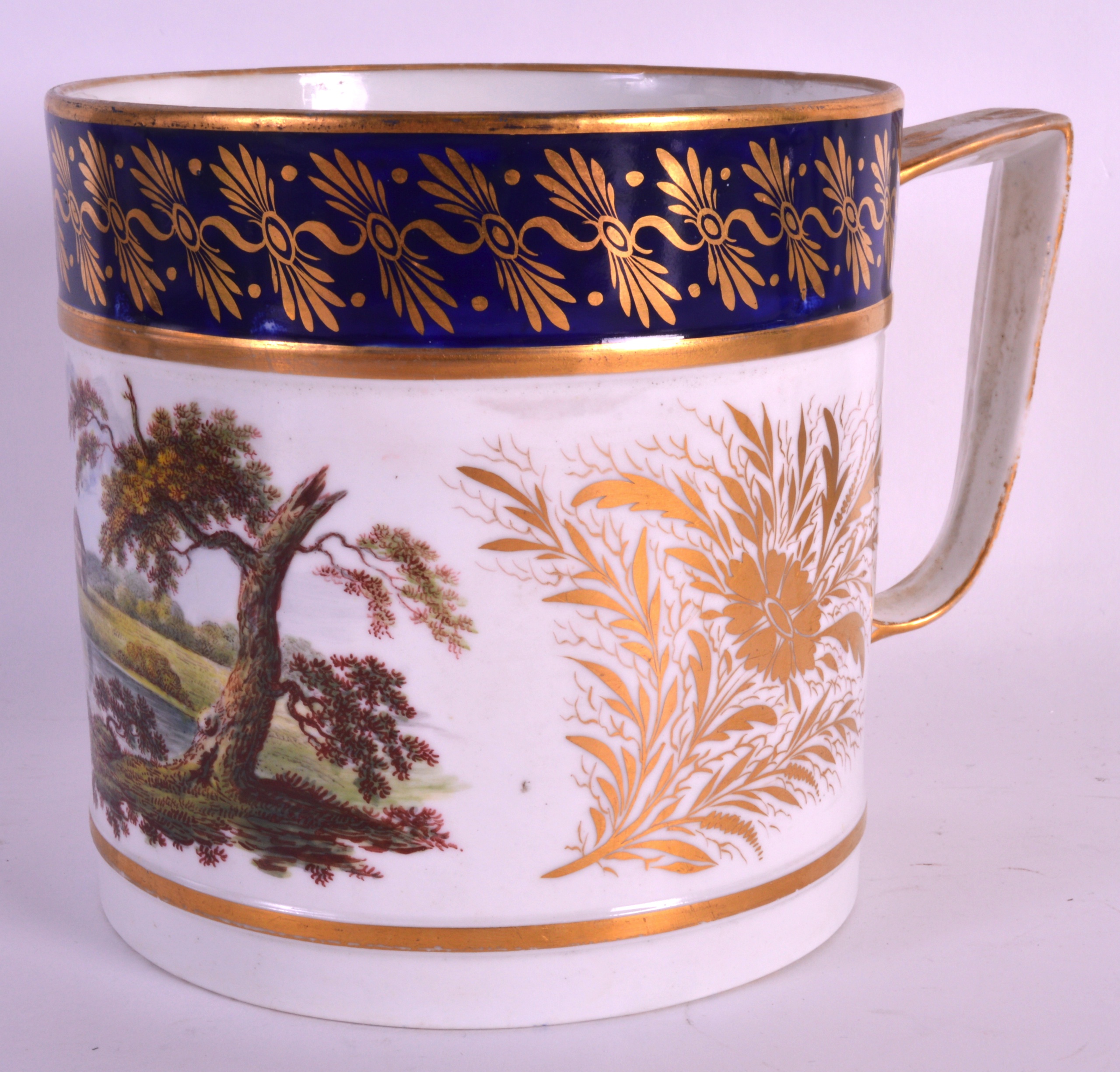 AN EARLY 19TH CENTURY DERBY PORTER MUG painted with a landscape, gilded with floral sprays between