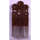 AN EARLY 20TH CENTURY CARVED WOOD TRIBAL COMB incised with figures. 10.5ins x 4.75ins.