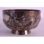 AN EARLY 20TH CENTURY CHINESE EXPORT SILVER BOWL by Wang Hing, decorated in relief with a dragon.