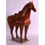 A LARGE 19TH CENTURY CHINESE SANCAI GLAZED POTTERY MODEL OF A HORSE in the Tang style, boldly