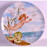 A LATE 19TH CENTURY MINTON ART POTTERY CHARGER painted with a nude winged cherub chasing